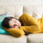 Woman Sleeping Comfortably In Living Room