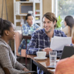 Diverse business team meets over coffee