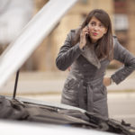 Young woman with car trouble