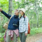 Mature husband and wife taking a walk in greenery