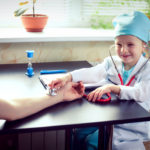 Young female doctor or nurse taking  patients