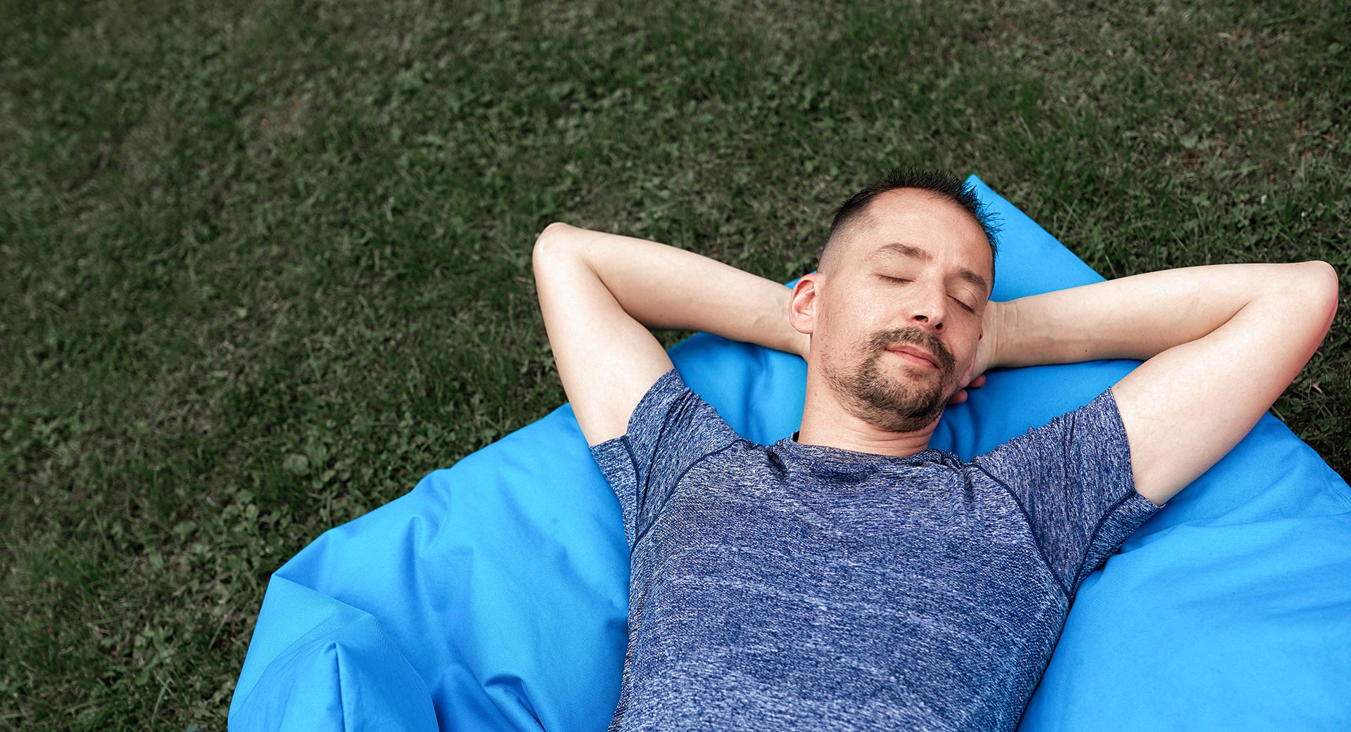 A man sleeping on grass