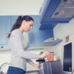 Young woman preparing breakfast in her kitchen