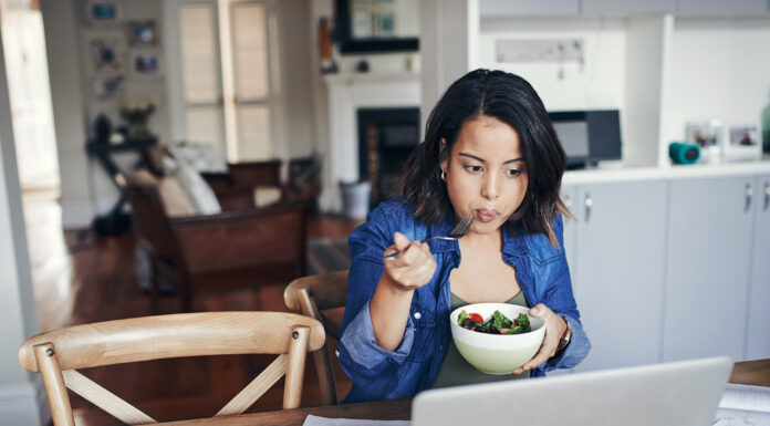 A woman looking at laptop screen