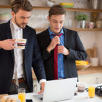 Young gay couple in the kitchen.