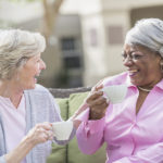 African American senior woman, friend talking over tea