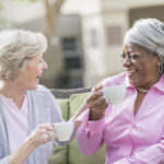 African American senior woman, friend talking over tea