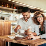 young couple enjoying drinks together at a coffee shop