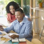 Couple reviewing paperwork at home