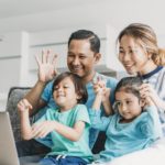 Happy family using laptop together