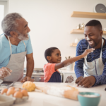 Grandfather father and child cooking together