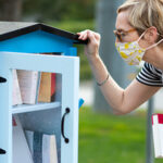 Woman looking into outside library shelf