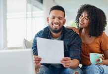 Couple sitting on couch looking at finances