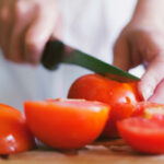 Slicing tomatoes with a knife