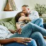 Dad hugging daughter on couch