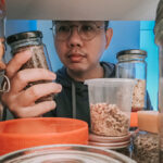 Man looking through refrigerator for food