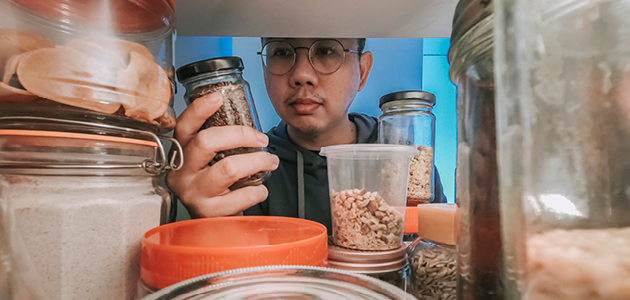 Man looking through refrigerator for food.