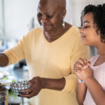 Woman with child cooking soup.