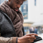 Man sitting outside reading a book