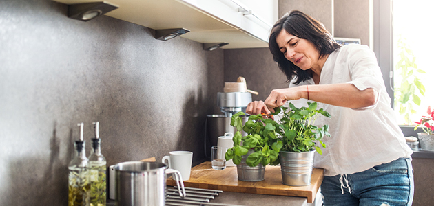 Woman potting plants for windowsill garden