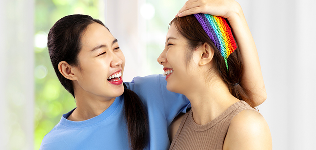 Two women smiling at each other