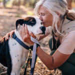 Woman cuddling her dog