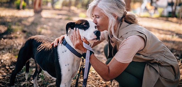 Woman cuddling her dog