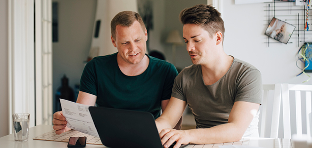 Two men sitting at a computer planning together