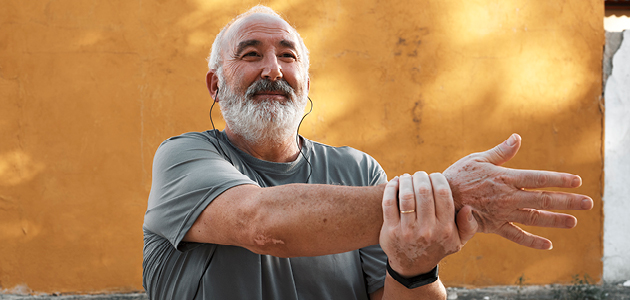 Grey-haired man stretching