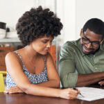 Man and woman looking at paperwork together