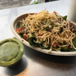 Mexican salad bowl from restaurant chain, Chipotle, with a side of guacamole