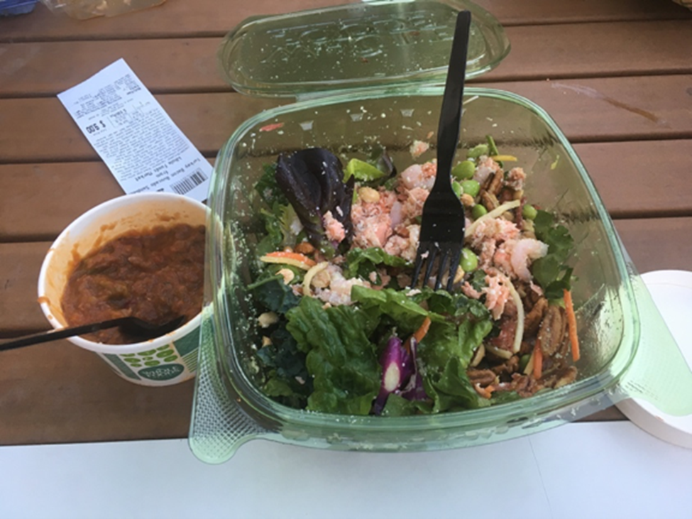 Salad and a small cup of chili from grocery chain, Whole Foods