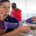 Kids decorating Hannukah cookies