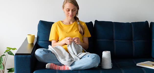 Woman knitting blanket