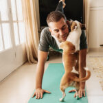 Man doing yoga with his dog