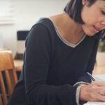 Woman writing in notebook