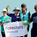 Group of Foresters members holding vegetables and fruit