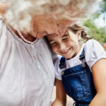 Grandma embracing her granddaughter.